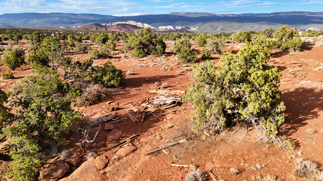 358 South Sky Drive Torrey, UT 84775 - Photo 59 of 82 Expansive desert landscape featuring red earth, scattered green shrubbery, and distant mountains under a blue sky