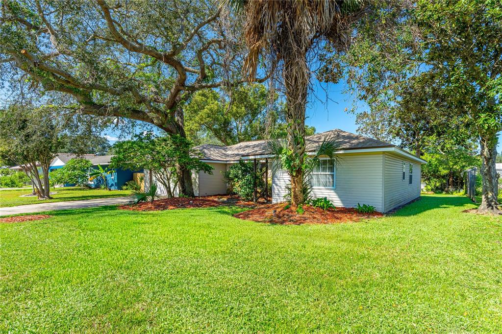 693 Reillys Road Port Orange, FL 32127 - Photo 2 of 31 a view of a wooden house with a yard