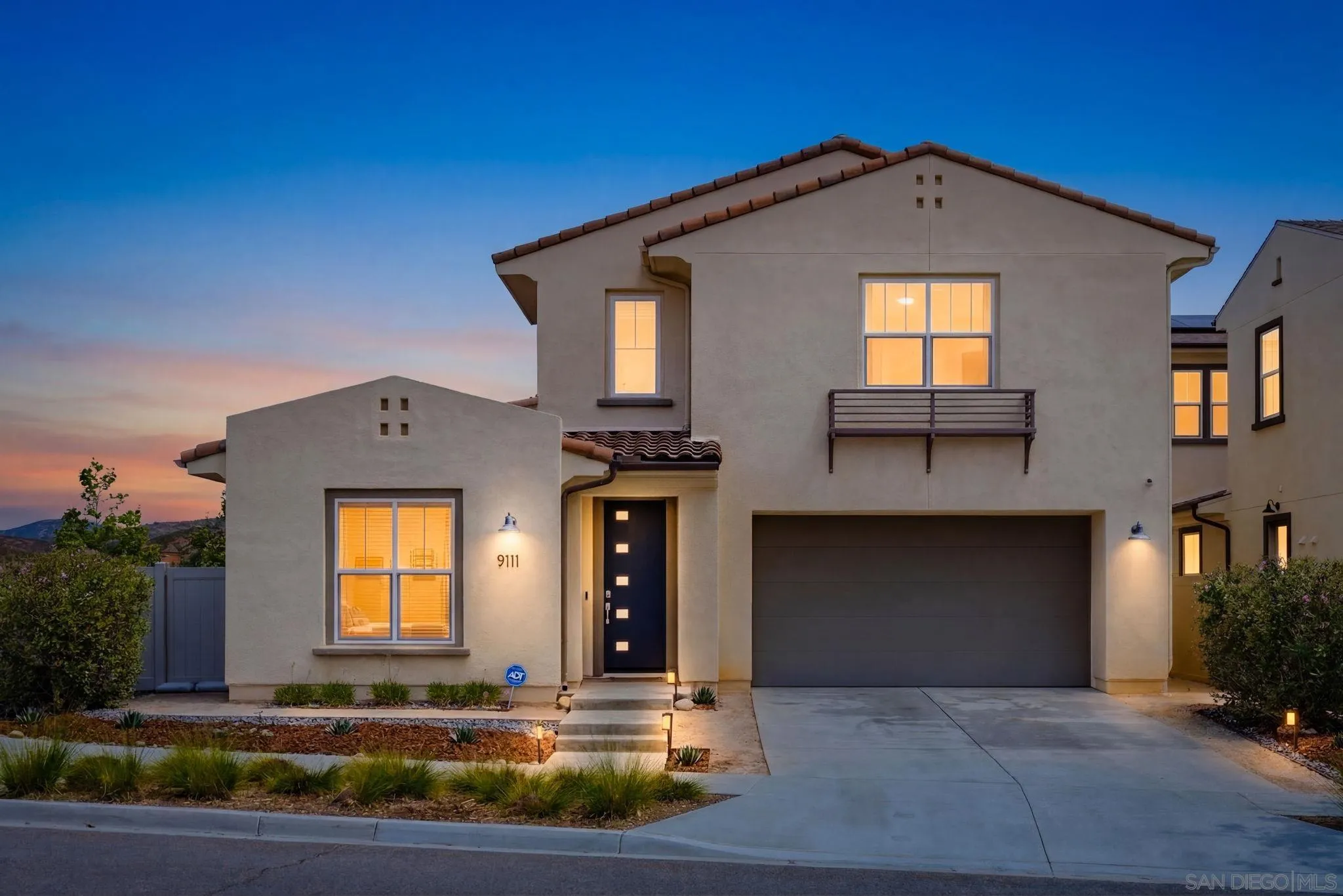 9111 West Bluff Place Santee, CA 92071 - Photo 1 of 36 a front view of a house with a yard
