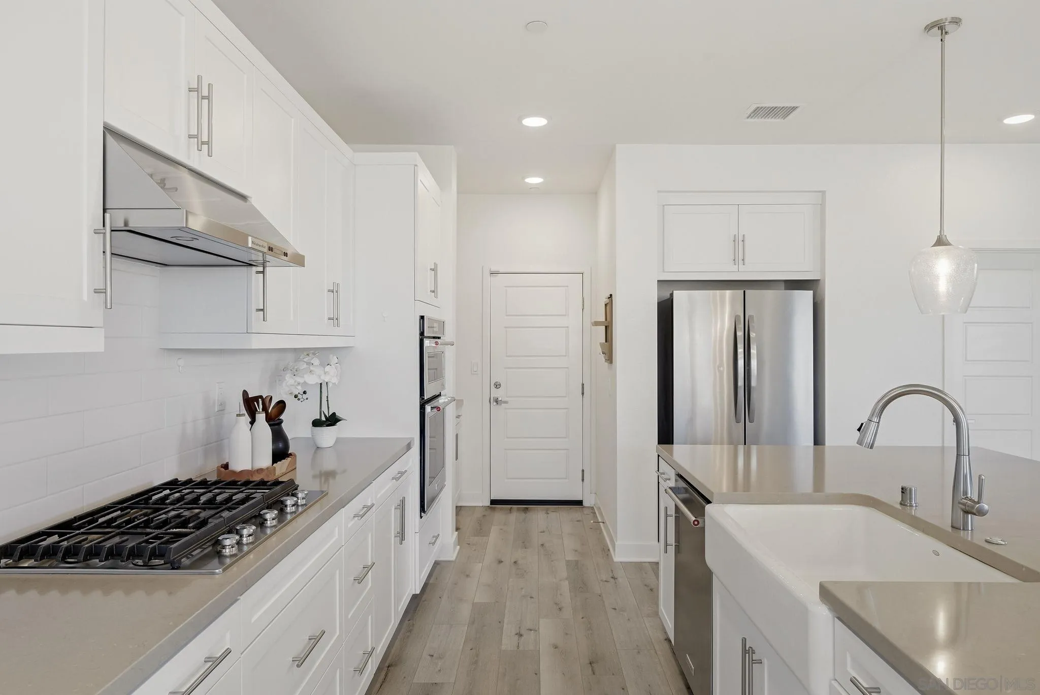 9111 West Bluff Place Santee, CA 92071 - Photo 11 of 36 a kitchen with stainless steel appliances a sink stove and refrigerator