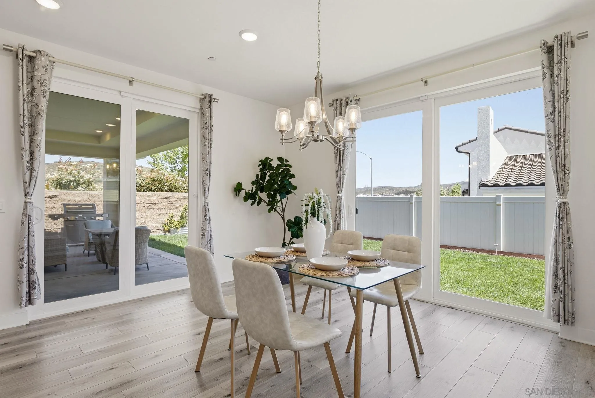 9111 West Bluff Place Santee, CA 92071 - Photo 12 of 36 a view of a dining room with furniture wooden floor and chandelier