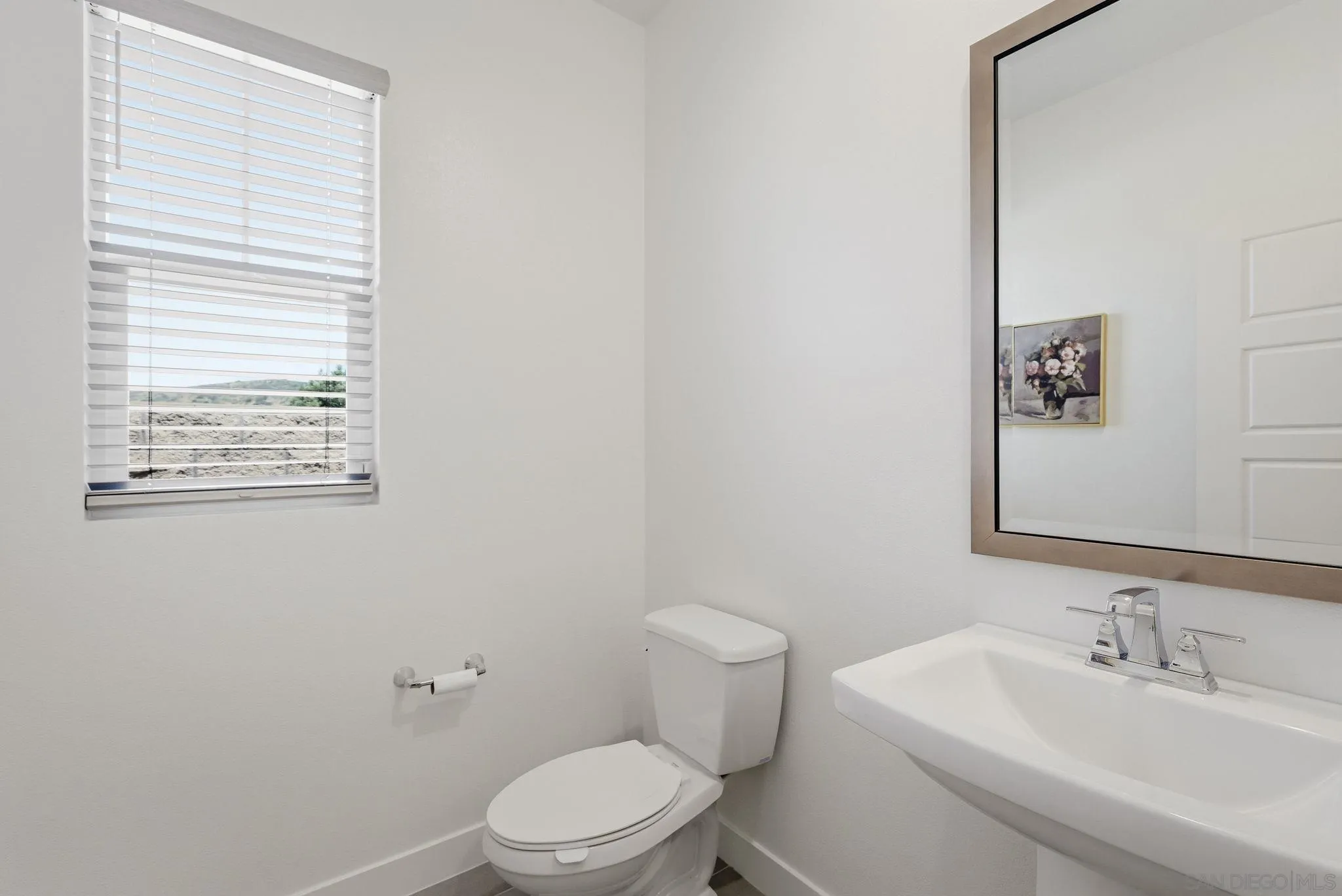 9111 West Bluff Place Santee, CA 92071 - Photo 16 of 36 a bathroom with a toilet a sink and a mirror