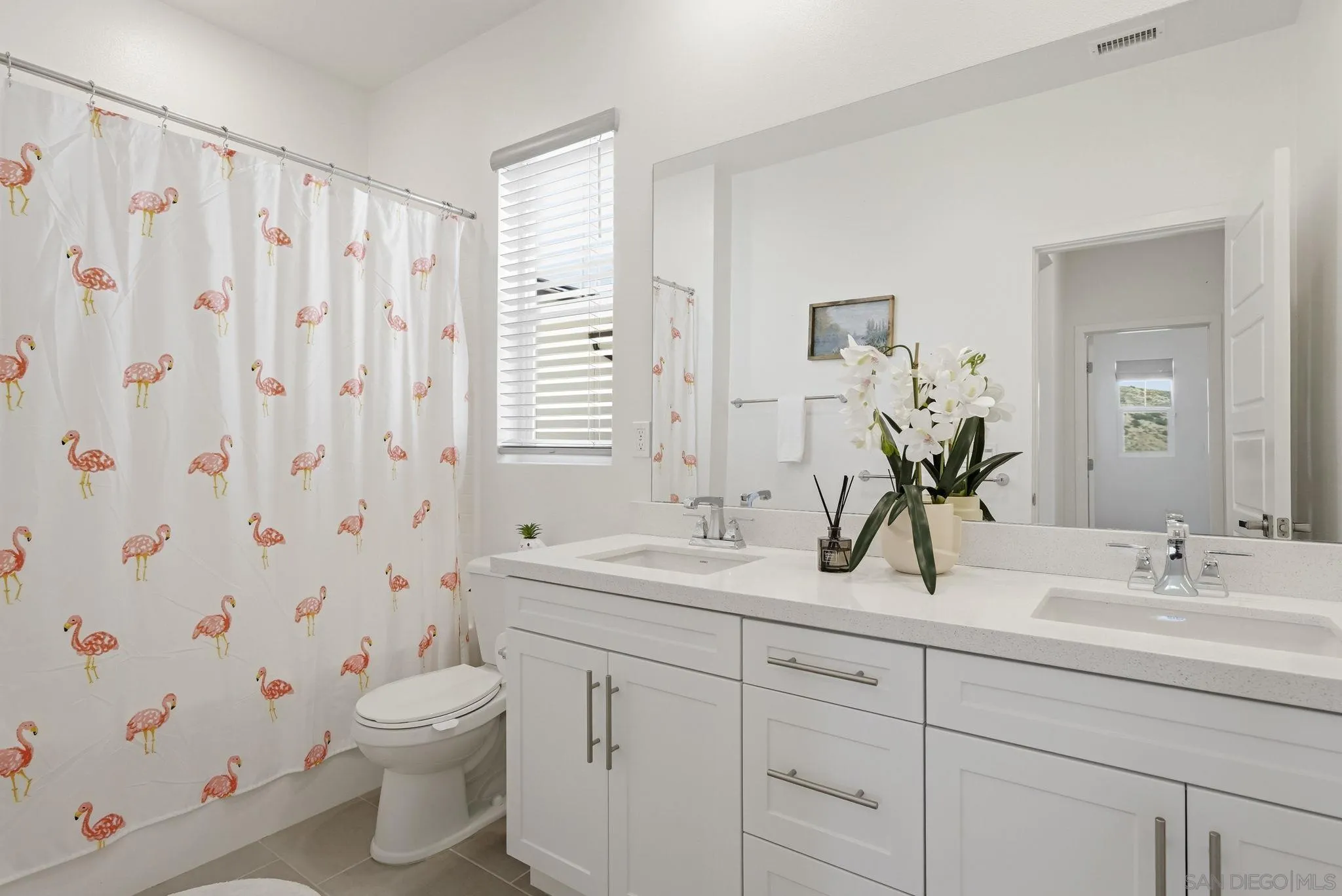 9111 West Bluff Place Santee, CA 92071 - Photo 33 of 36 a bathroom with a double vanity sink toilet and a mirror