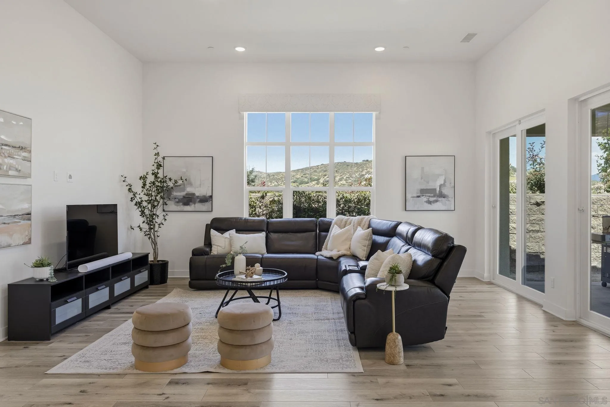 9111 West Bluff Place Santee, CA 92071 - Photo 6 of 36 a living room with furniture a flat screen tv and wooden floor