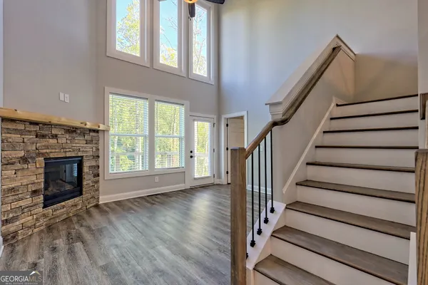 a view of a hallway with wooden floor and entryway