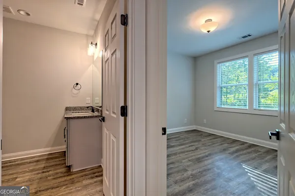 a view of a hallway with wooden floor
