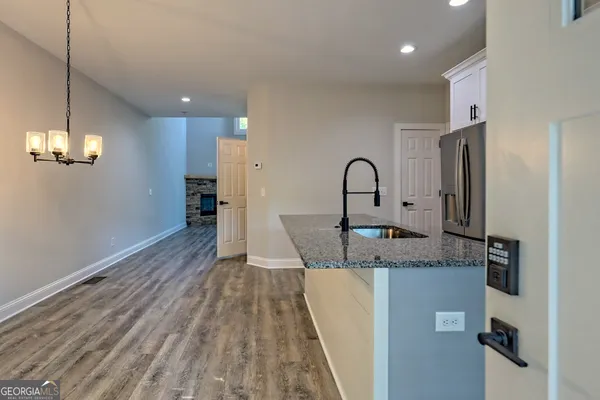a kitchen with stainless steel appliances granite countertop a sink stove and cabinets