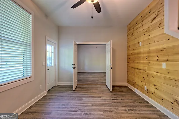 a kitchen with stainless steel appliances granite countertop white cabinets and a stove top oven