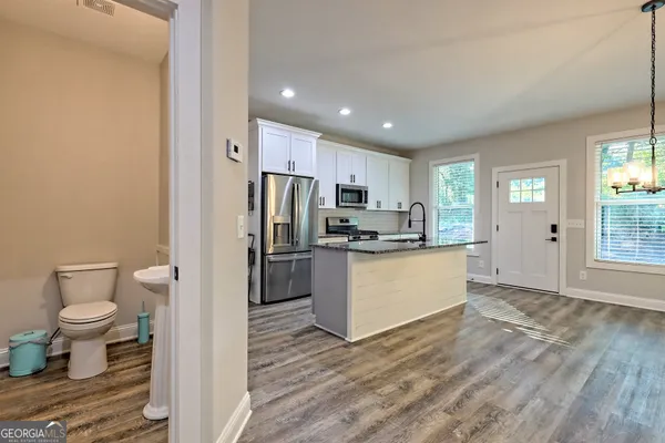 a view of a livingroom with wooden floor and a fireplace