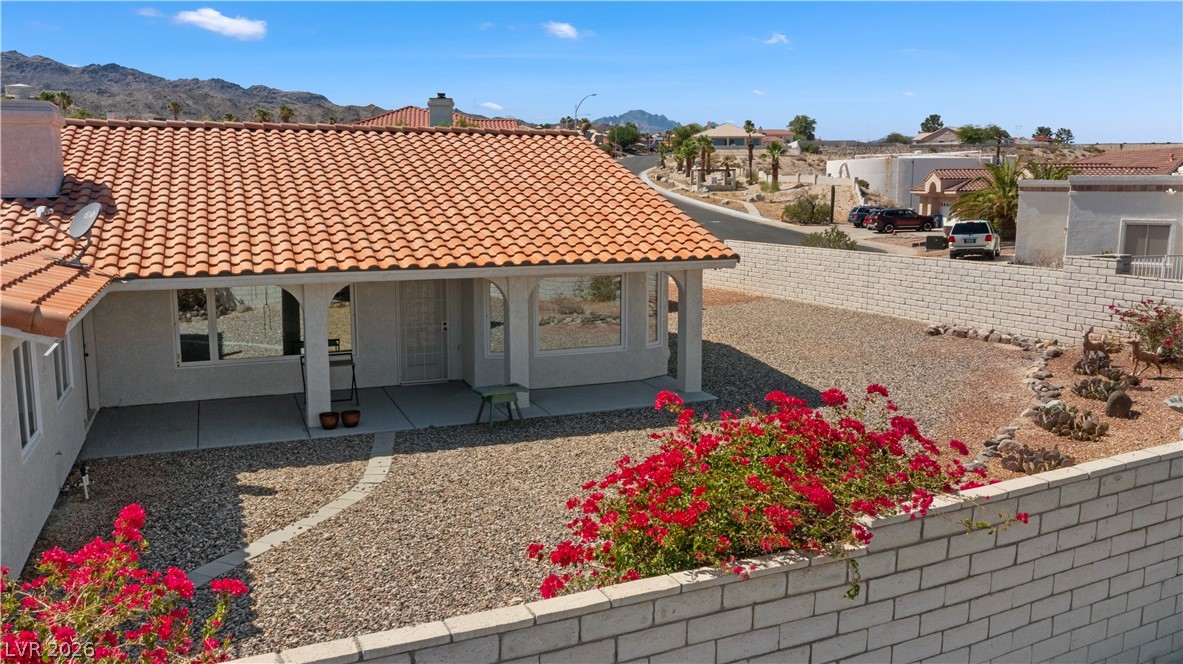 2055 Cholla Way Laughlin, NV 89029 - Photo 80 of 87 A terracotta-tiled roof crowns this residence, featuring a covered patio and xeriscape landscaping.