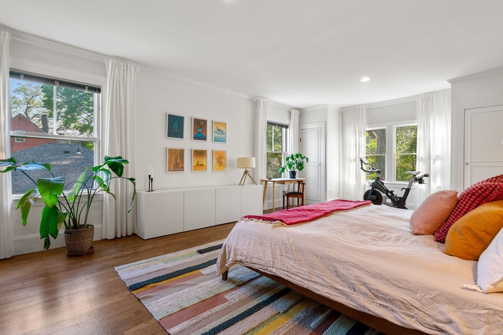999 Walnut Street Newton, MA 02461 - Photo 23 of 38 a bedroom with a bed and a potted plant