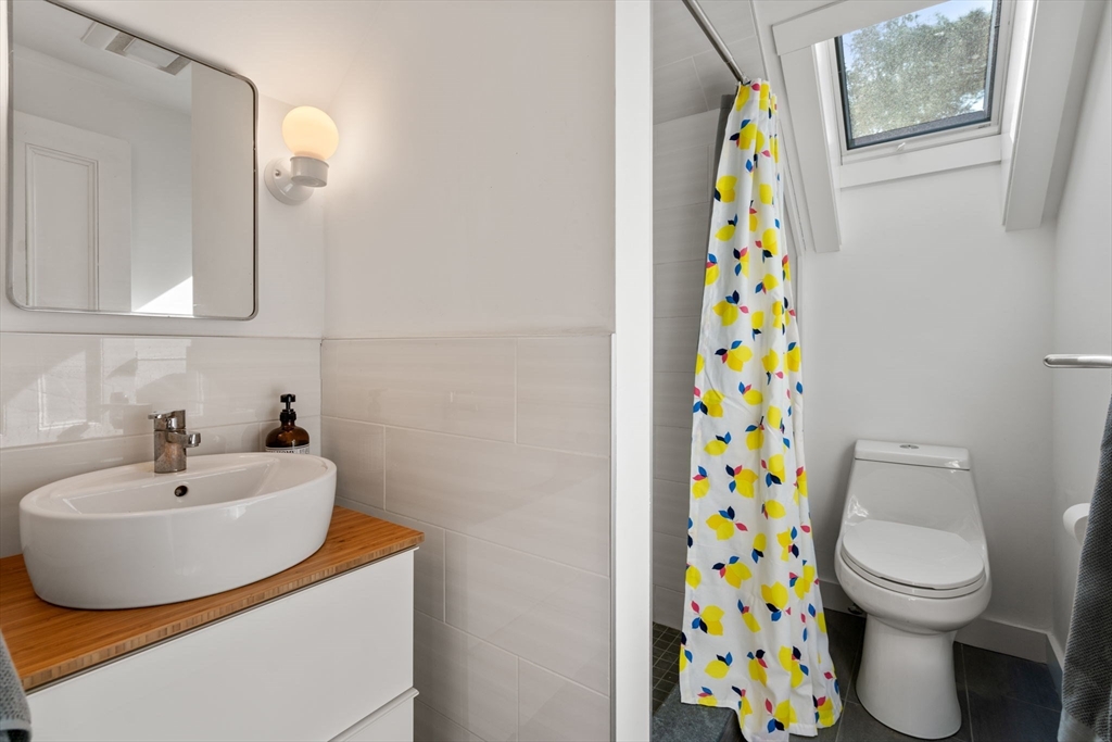 999 Walnut Street Newton, MA 02461 - Photo 29 of 38 a bathroom with a sink and a toilet