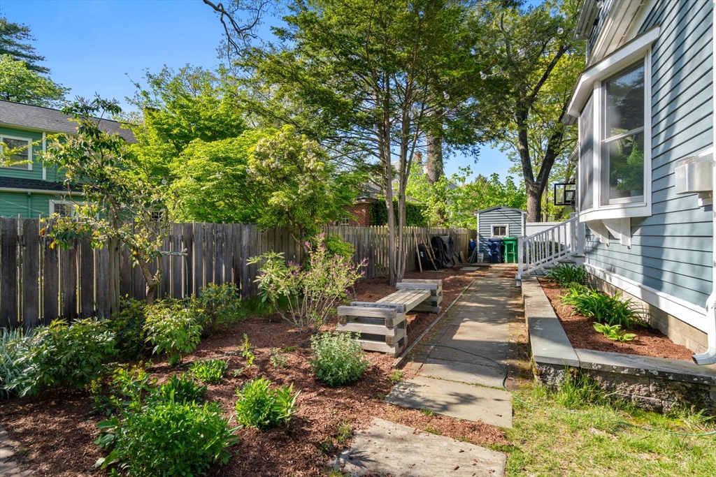 999 Walnut Street Newton, MA 02461 - Photo 35 of 38 a view of a backyard with potted plants and large tree