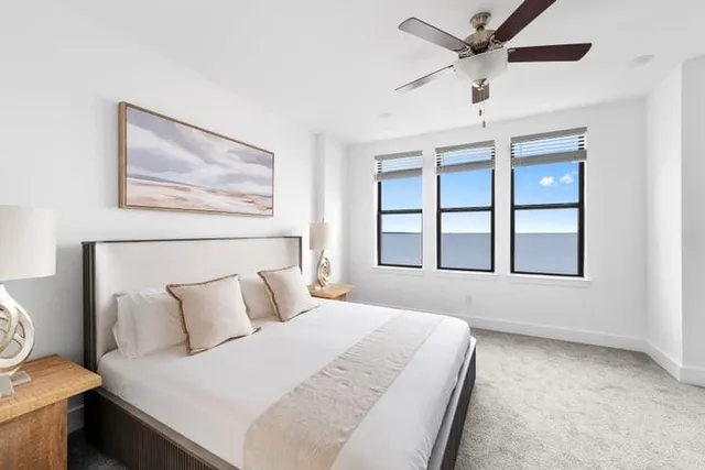 a bedroom with a large bed and a window