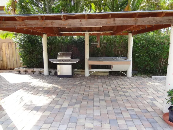 a view of a patio with a table and chairs next to a yard
