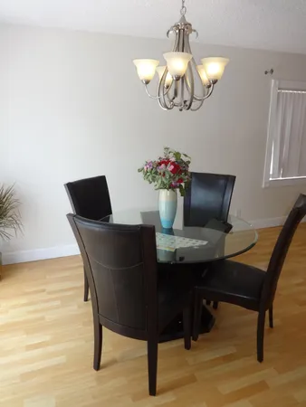 a view of a dining room with furniture and chandelier