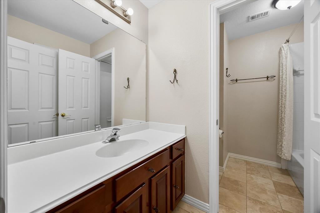 645 Channel Ridge Drive Rockwall, TX 75087 - Photo 26 of 40 The hall bath has a door separating the vanity and wet areas, allowing privacy during simultaneous use.