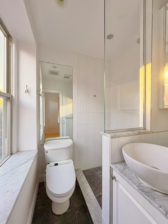 11 Unity Street, Unit 8 Boston, MA 02113 - Photo 16 of 20 a bathroom with a granite countertop toilet and a sink