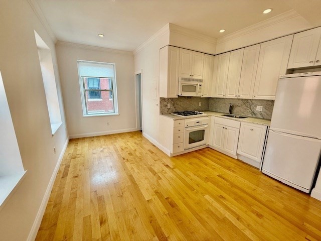11 Unity Street, Unit 8 Boston, MA 02113 - Photo 6 of 20 a kitchen with a sink a refrigerator and window