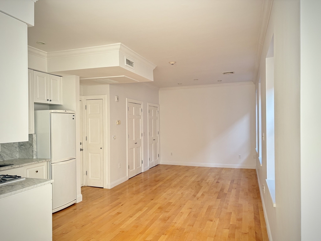 11 Unity Street, Unit 8 Boston, MA 02113 - Photo 10 of 20 a view of a kitchen with wooden floor