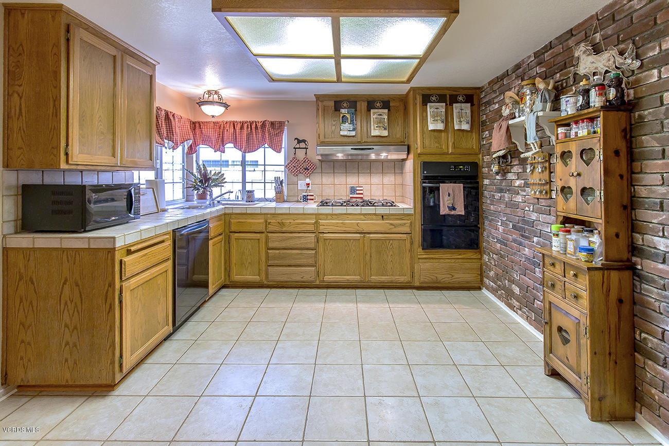 2942 Racine Street Simi Valley, CA 93065 - Photo 13 of 37 a kitchen with stainless steel appliances granite countertop a sink and cabinets