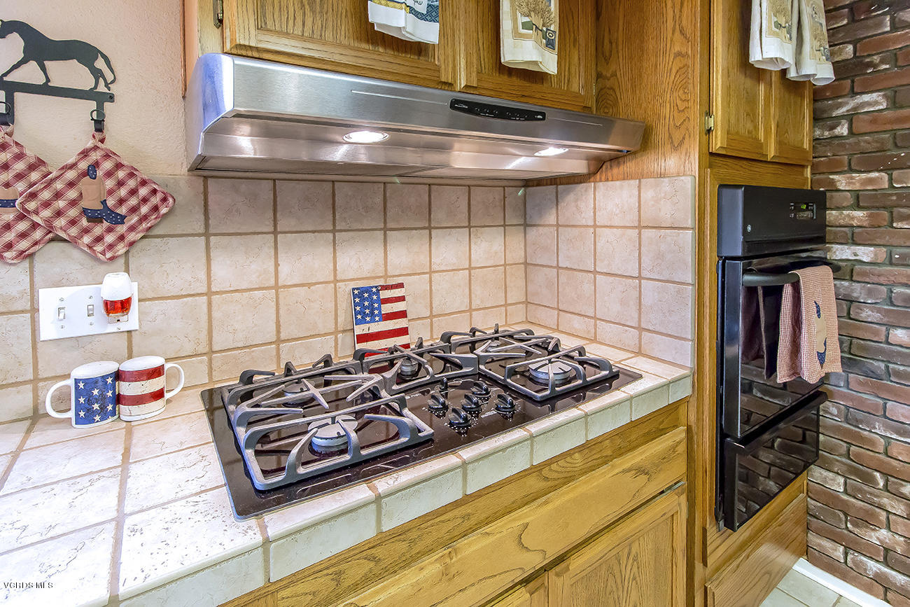 2942 Racine Street Simi Valley, CA 93065 - Photo 16 of 37 a kitchen with a stove and cabinets