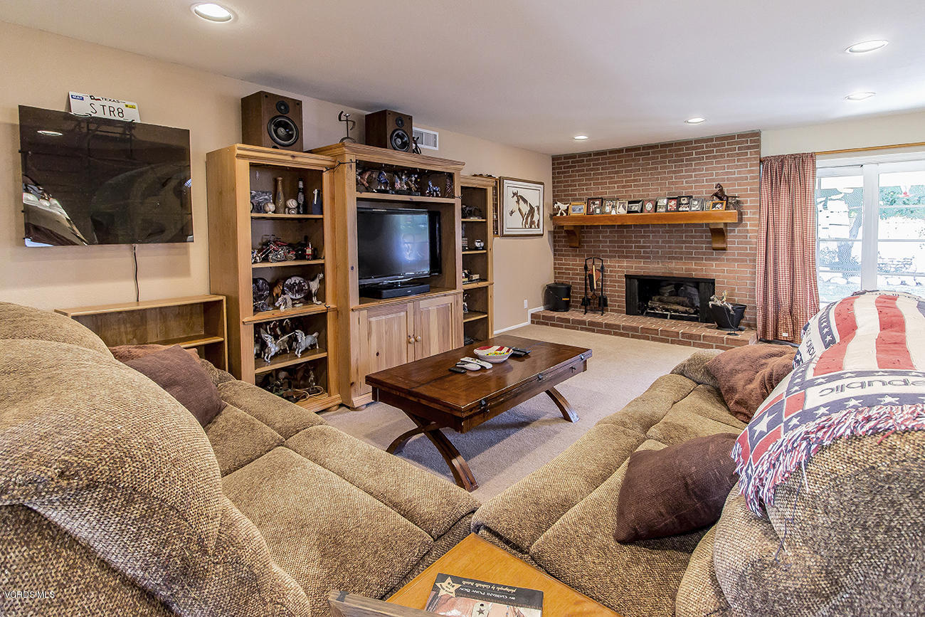 2942 Racine Street Simi Valley, CA 93065 - Photo 10 of 37 a living room with furniture a flat screen tv and a fireplace