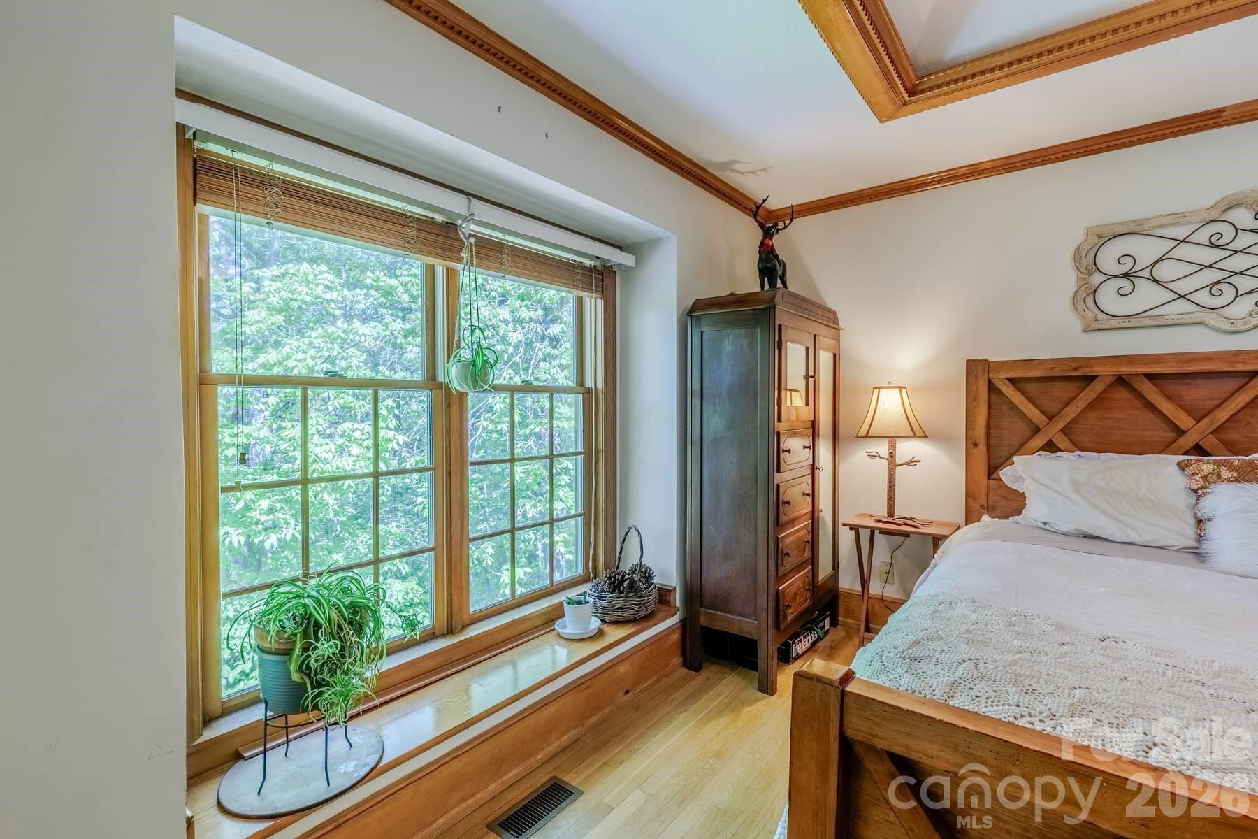 97 Covered Bridge Road Robbinsville, NC 28771 - Photo 21 of 45 a bedroom with a bed and a window