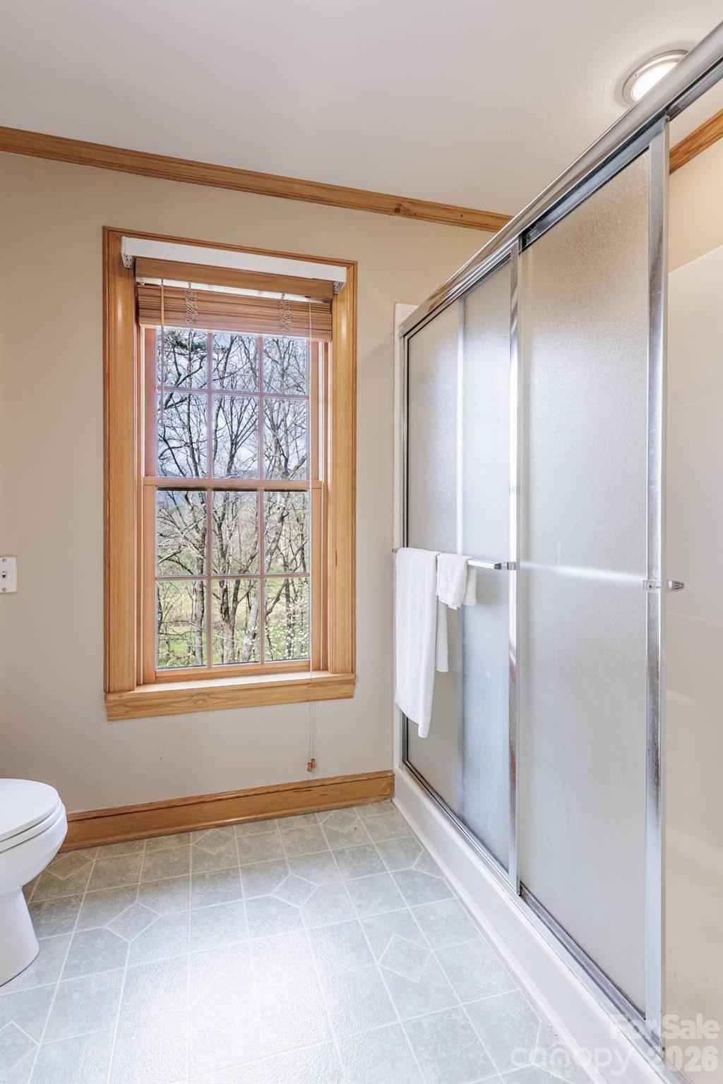 97 Covered Bridge Road Robbinsville, NC 28771 - Photo 23 of 45 a view of an empty room with a window and bathroom