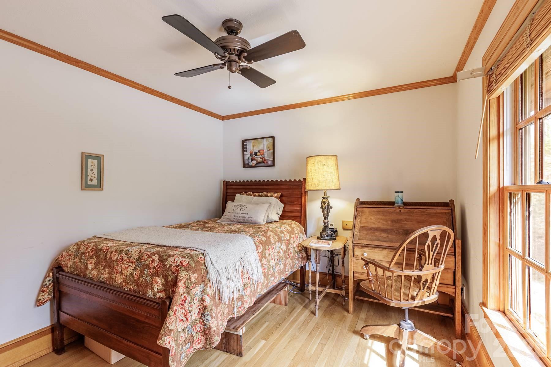 97 Covered Bridge Road Robbinsville, NC 28771 - Photo 24 of 45 a bedroom with a bed and wooden floor