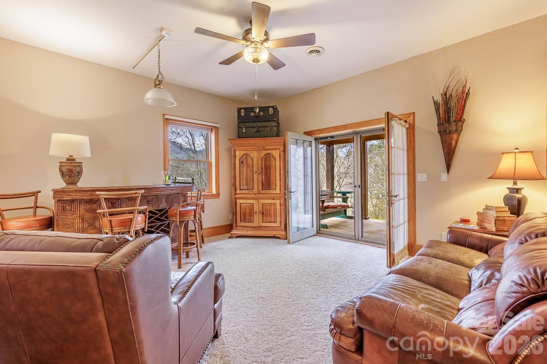 97 Covered Bridge Road Robbinsville, NC 28771 - Photo 27 of 45 a living room with furniture and a large window