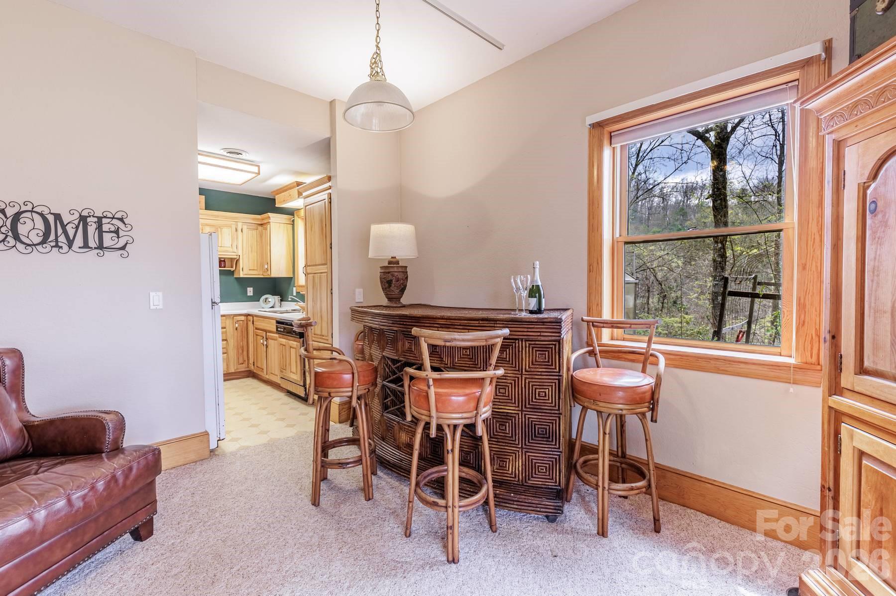 97 Covered Bridge Road Robbinsville, NC 28771 - Photo 29 of 45 a dining room with furniture and window