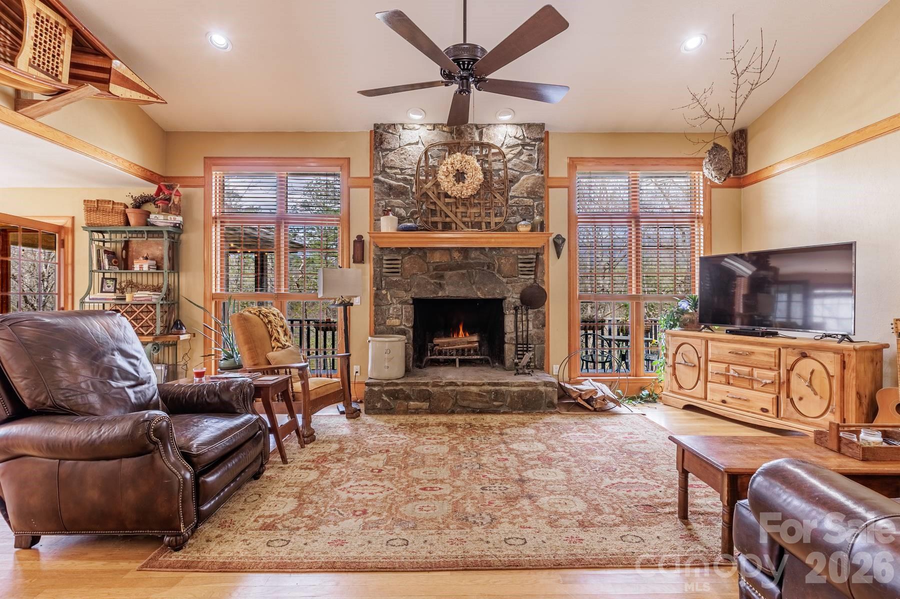 97 Covered Bridge Road Robbinsville, NC 28771 - Photo 3 of 45 a living room with furniture a flat screen tv and a fireplace