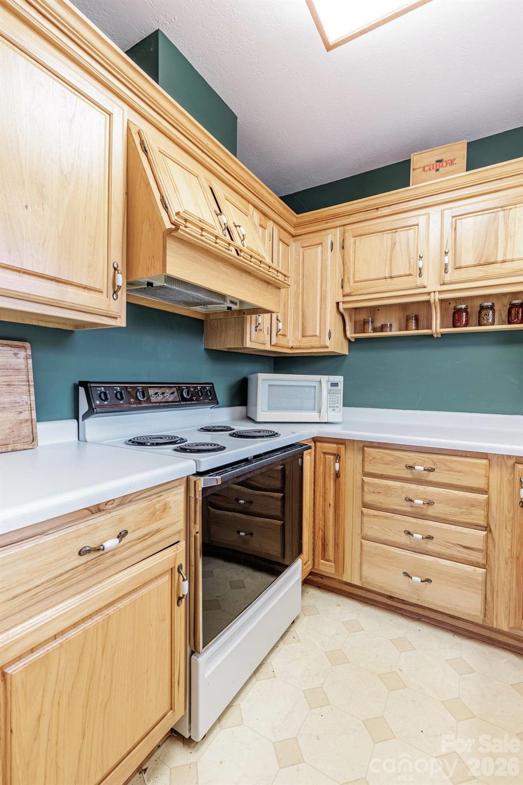 97 Covered Bridge Road Robbinsville, NC 28771 - Photo 31 of 45 a kitchen with granite countertop a stove and a sink