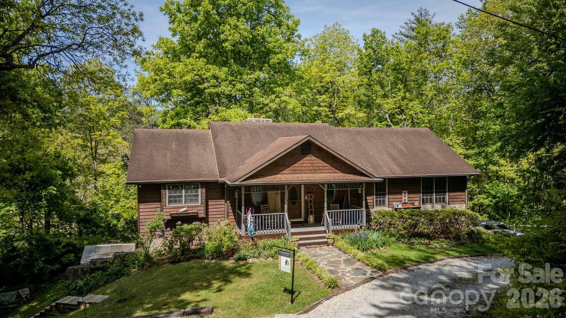 97 Covered Bridge Road Robbinsville, NC 28771 - Photo 40 of 45 a house view with a garden space