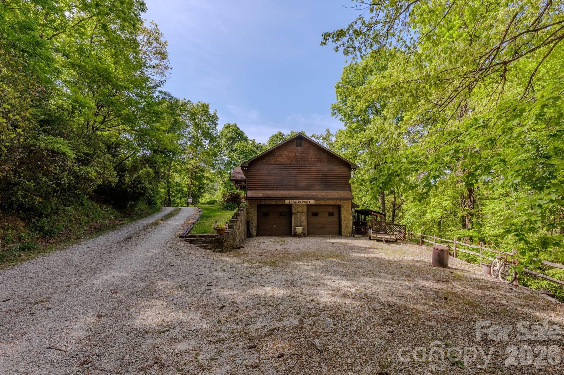 97 Covered Bridge Road Robbinsville, NC 28771 - Photo 42 of 45 a view of a house with a yard and garage
