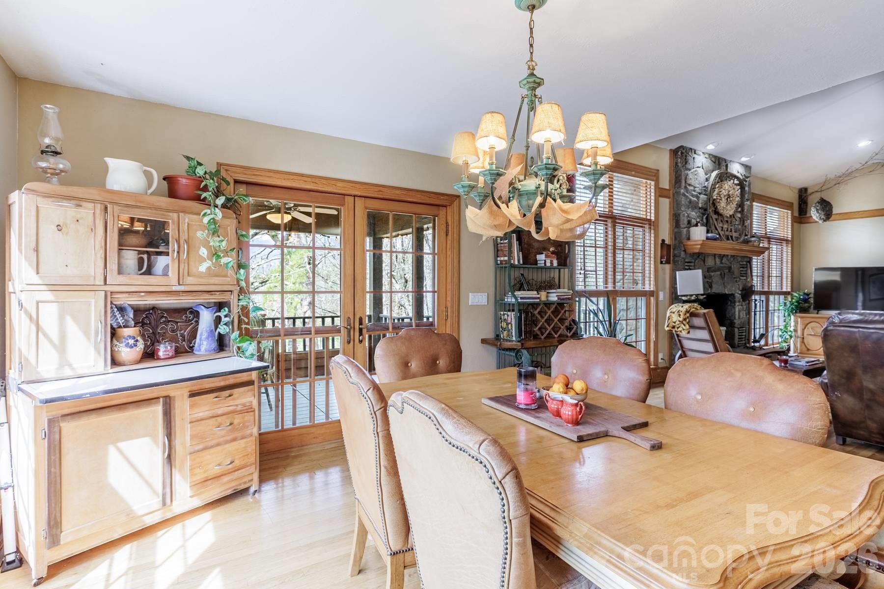 97 Covered Bridge Road Robbinsville, NC 28771 - Photo 6 of 45 a dining room with furniture and a chandelier