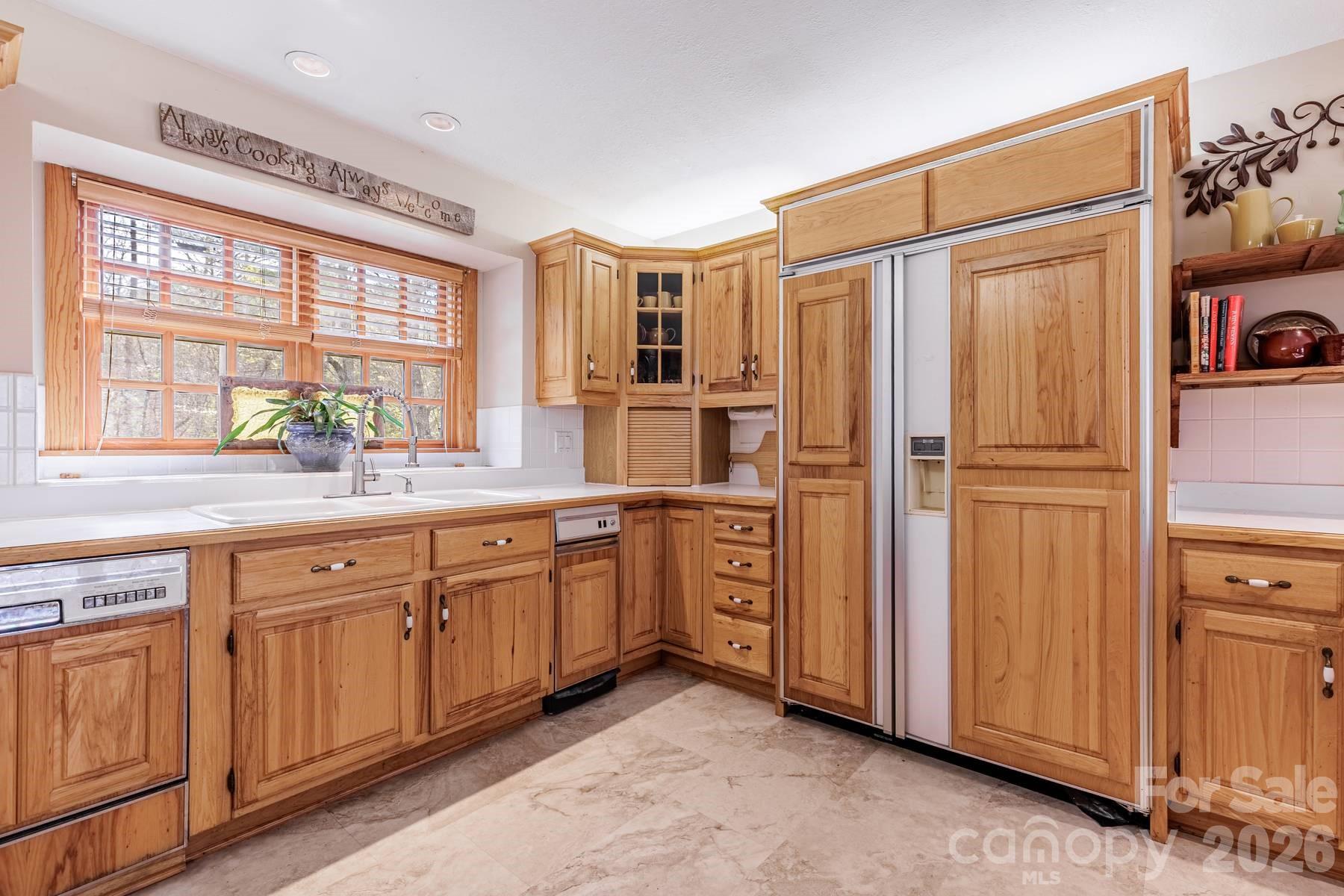 97 Covered Bridge Road Robbinsville, NC 28771 - Photo 8 of 45 a kitchen with stainless steel appliances granite countertop a refrigerator and cabinets