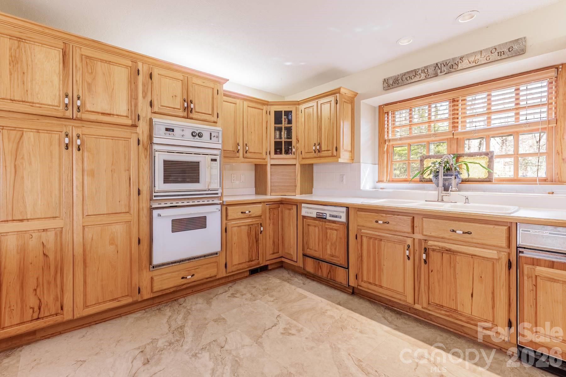 97 Covered Bridge Road Robbinsville, NC 28771 - Photo 9 of 45 a kitchen with granite countertop cabinets and white appliances