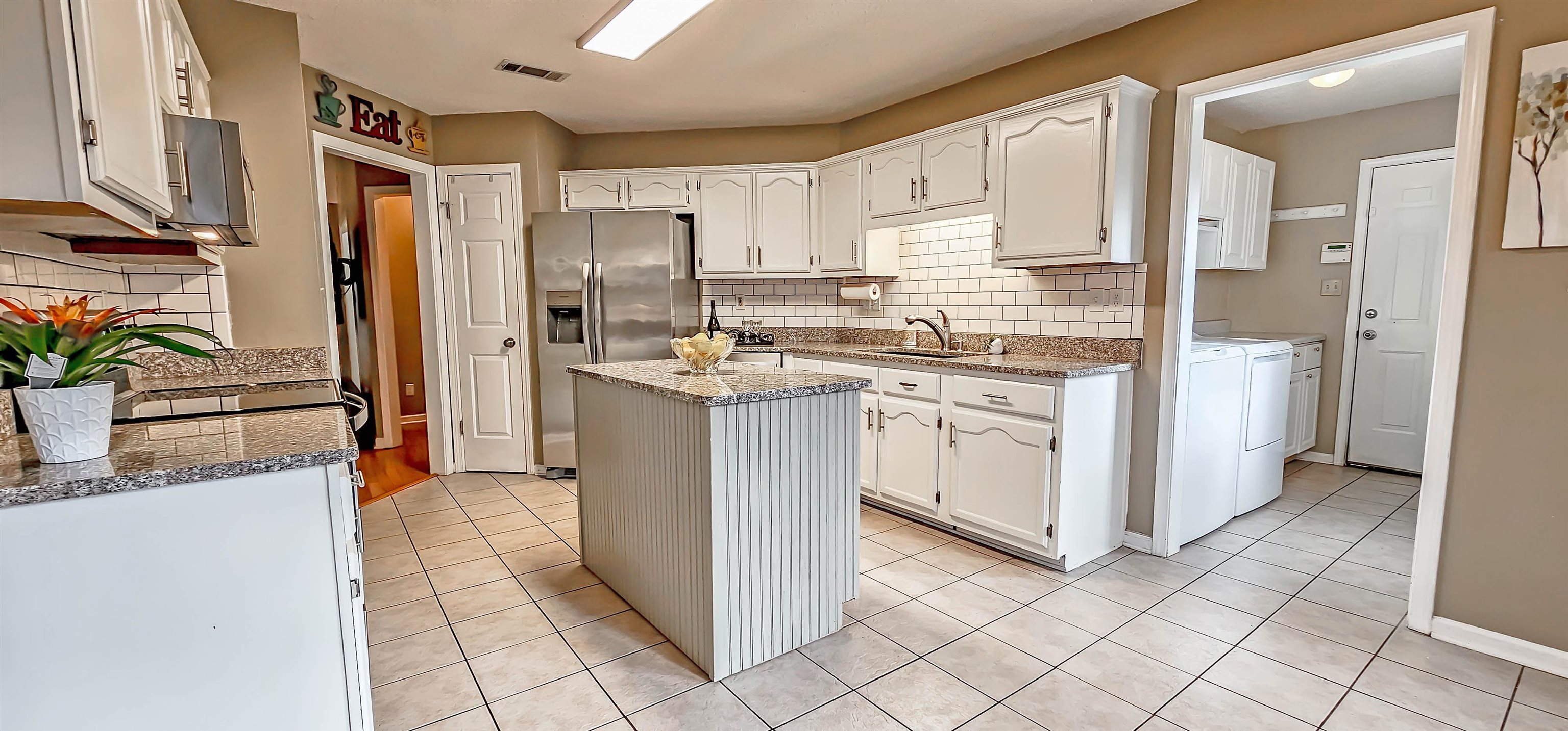 251 Summit View Cove Collierville, TN 38017 - Photo 12 of 30 a kitchen with stainless steel appliances granite countertop a stove a sink and a refrigerator
