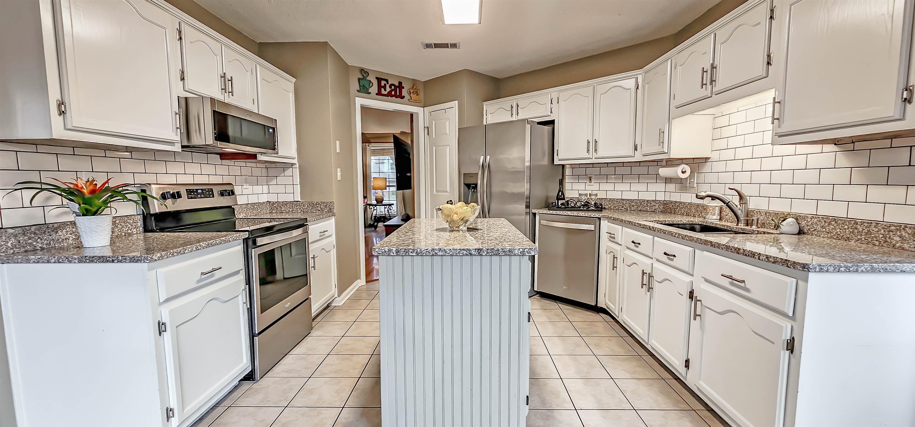 251 Summit View Cove Collierville, TN 38017 - Photo 13 of 30 a kitchen with cabinets stainless steel appliances and a sink