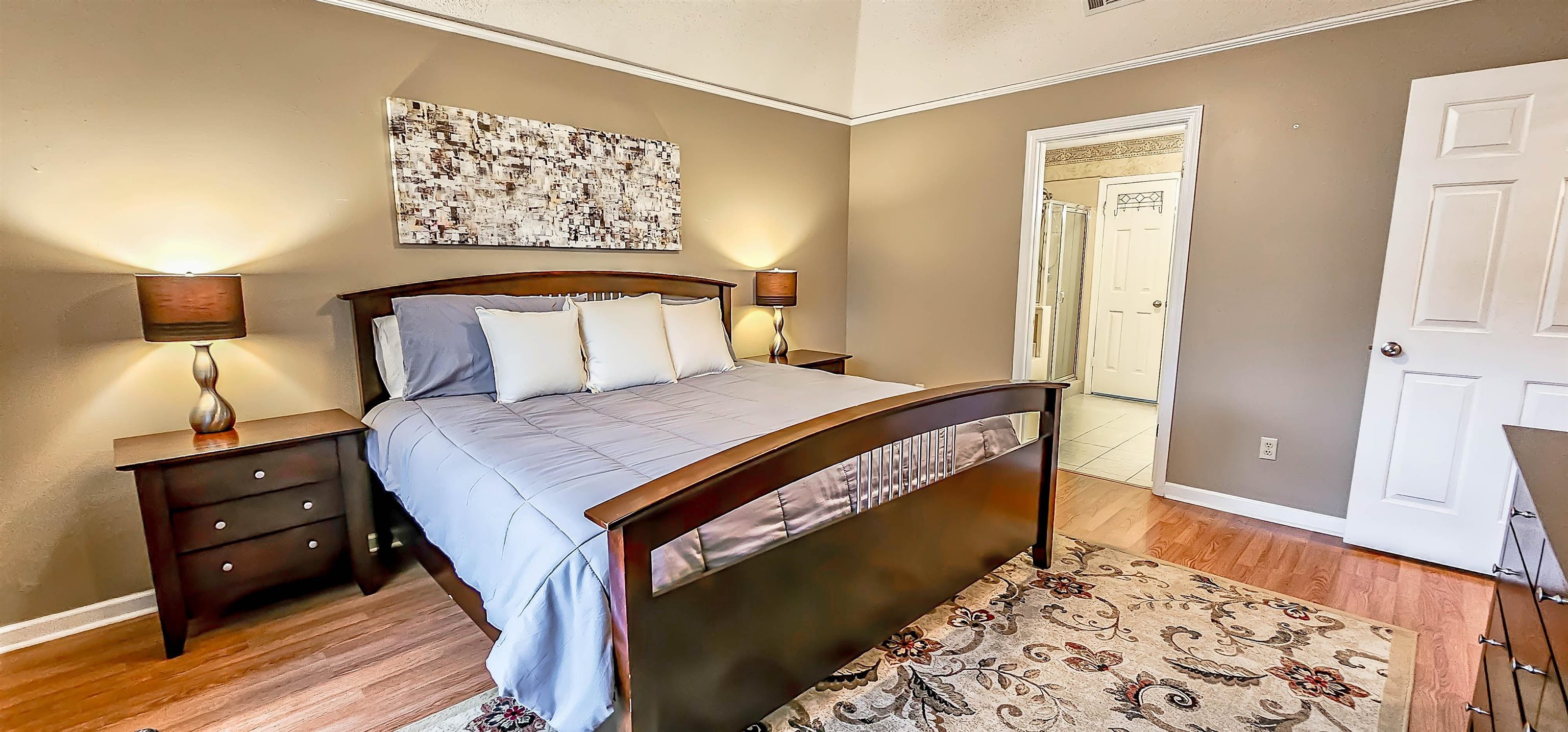 251 Summit View Cove Collierville, TN 38017 - Photo 17 of 30 a bedroom with a bed and a dresser with wooden floor