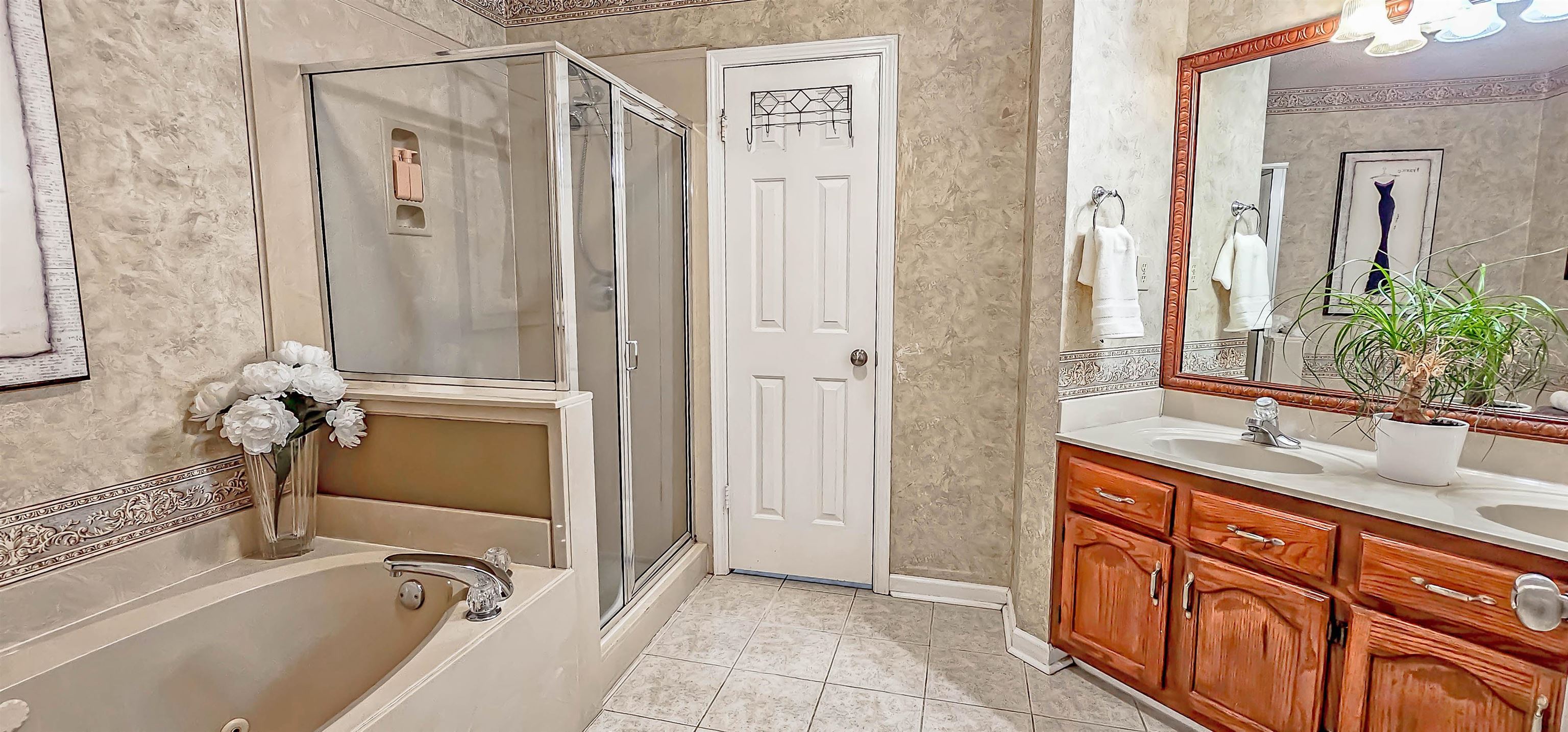251 Summit View Cove Collierville, TN 38017 - Photo 18 of 30 a bathroom with a tub sink and mirror