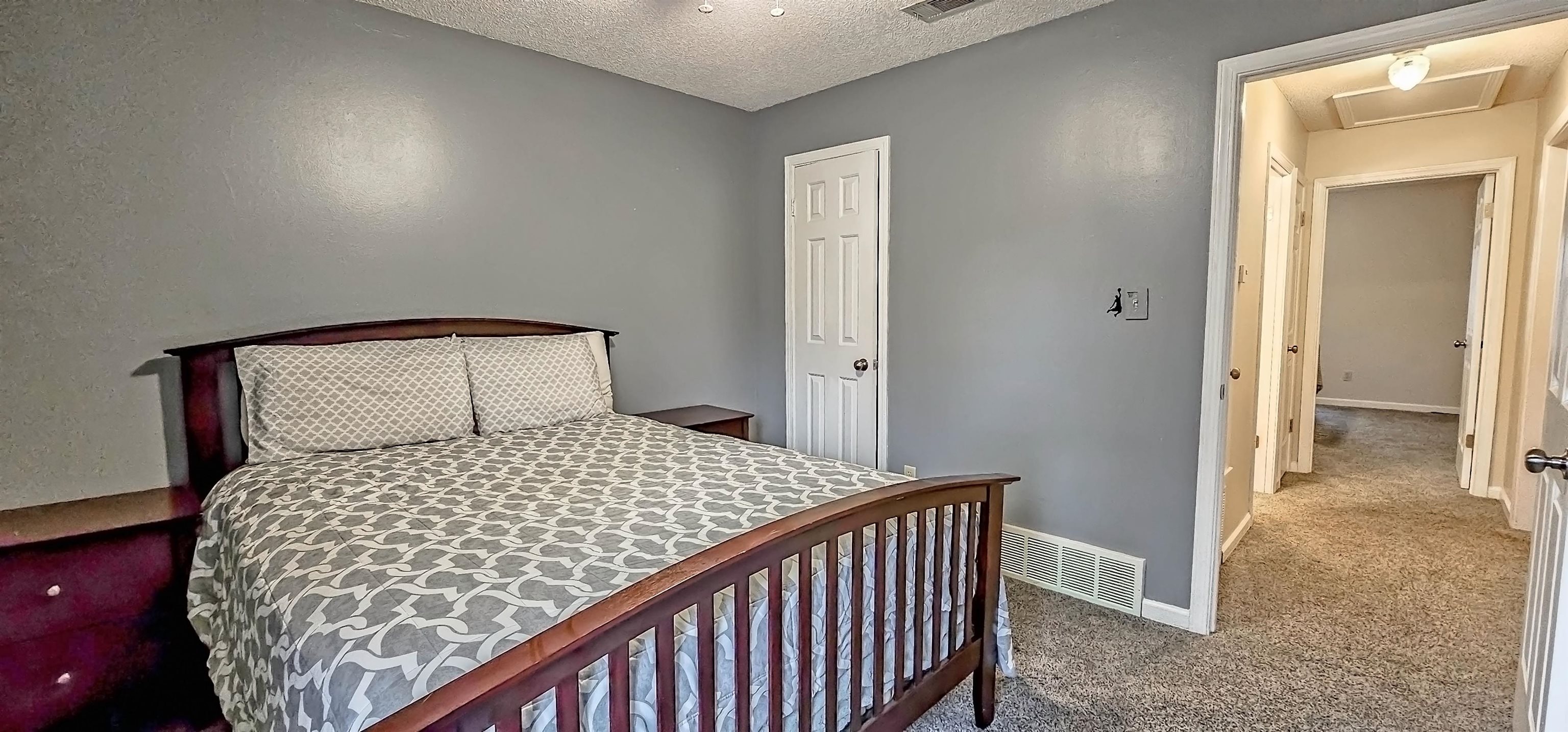 251 Summit View Cove Collierville, TN 38017 - Photo 23 of 30 a bedroom with a bed and a view of bathroom