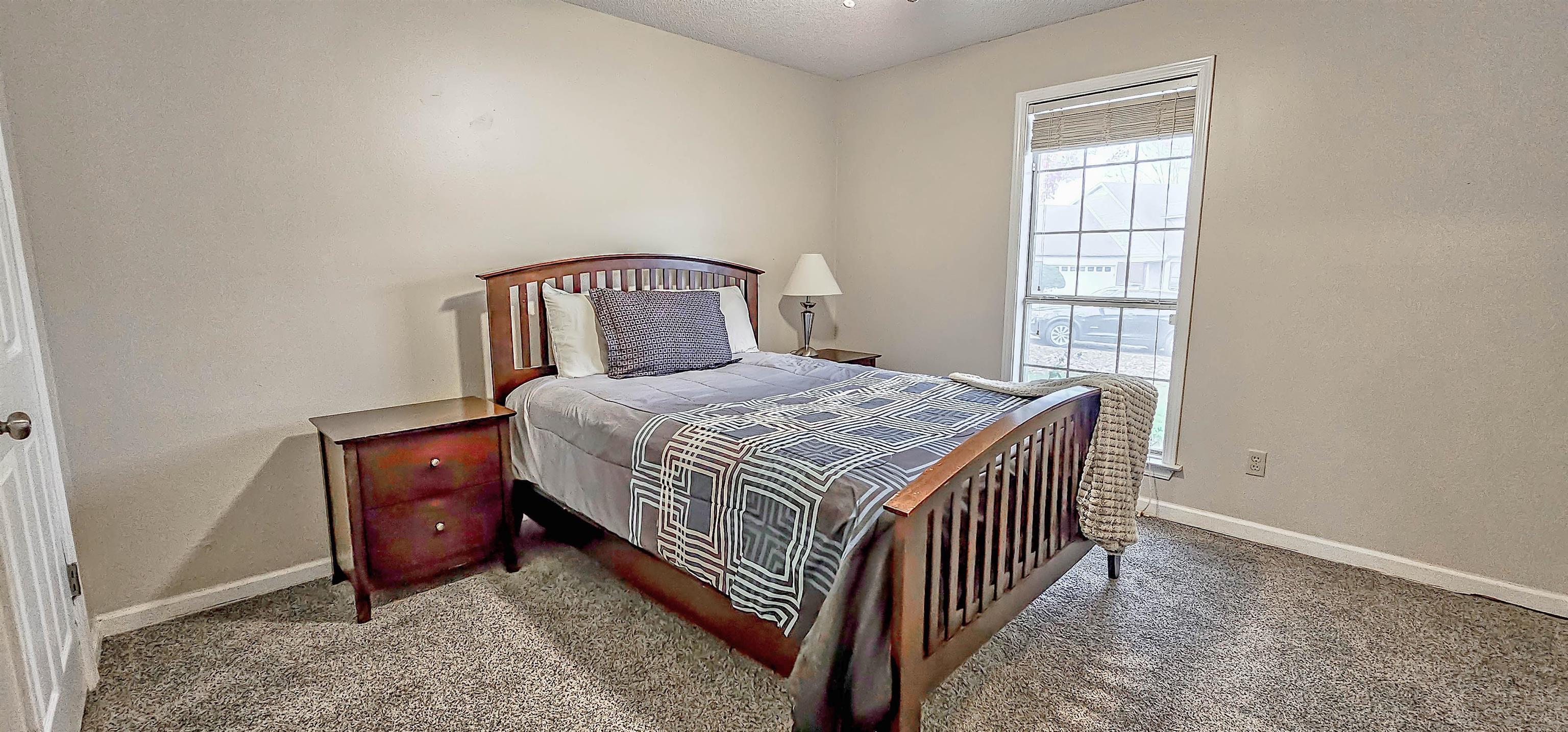 251 Summit View Cove Collierville, TN 38017 - Photo 24 of 30 a bedroom with a bed and a window