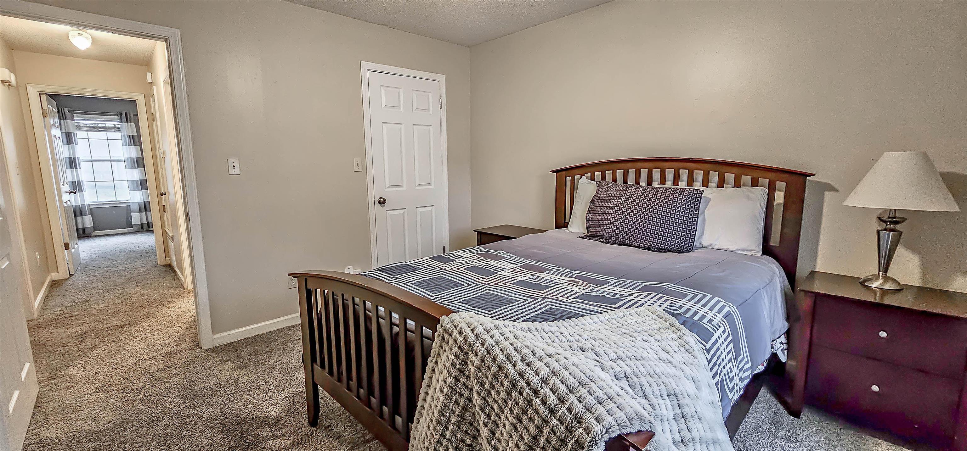 251 Summit View Cove Collierville, TN 38017 - Photo 25 of 30 a bedroom with a bed and a lamp on table