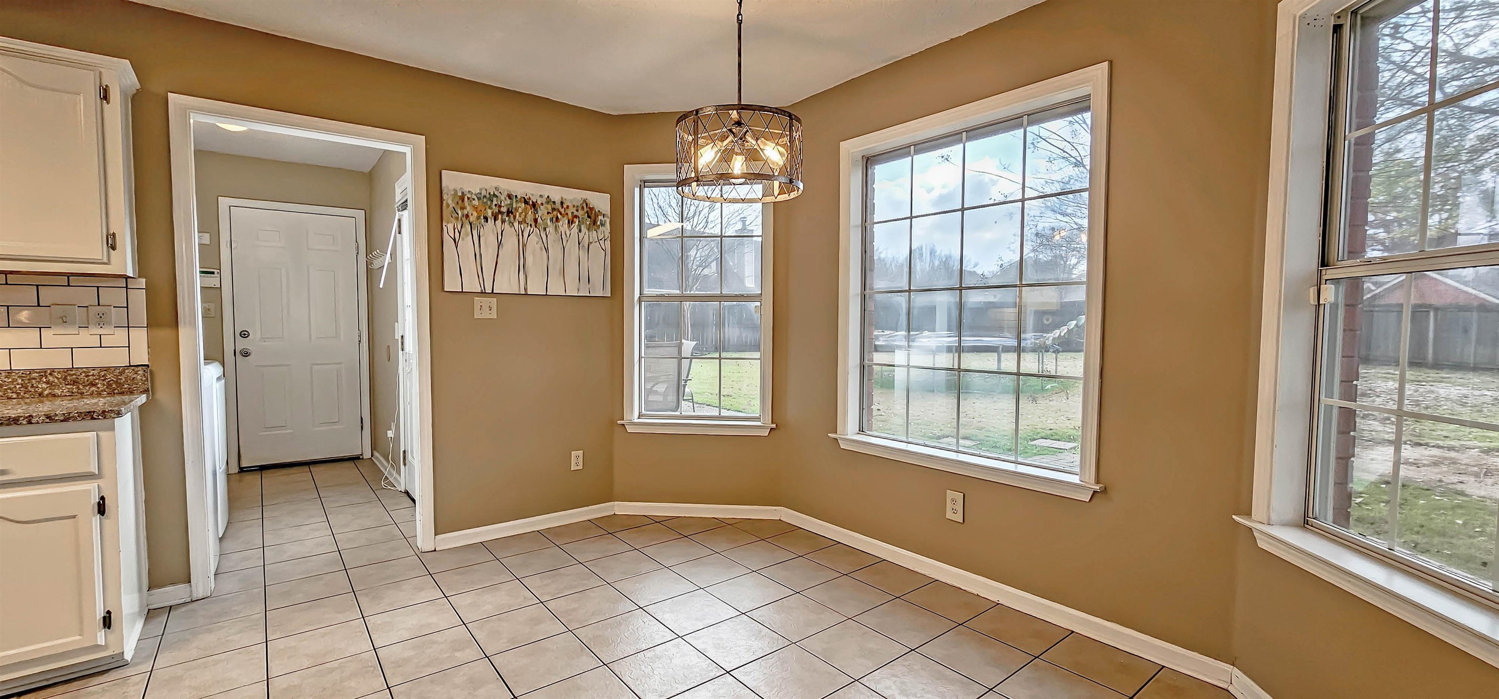 251 Summit View Cove Collierville, TN 38017 - Photo 10 of 30 a view of an empty room with window and chandelier