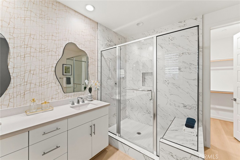 127 Restore Irvine, CA 92618 - Photo 25 of 65 a bathroom with a shower sink and mirror