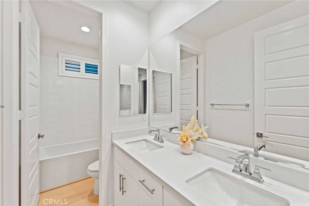 127 Restore Irvine, CA 92618 - Photo 30 of 65 a bathroom with a sink double vanity granite tub shower and a mirror