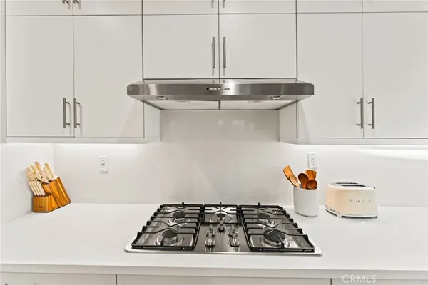 a kitchen with stainless steel appliances a refrigerator sink and cabinets